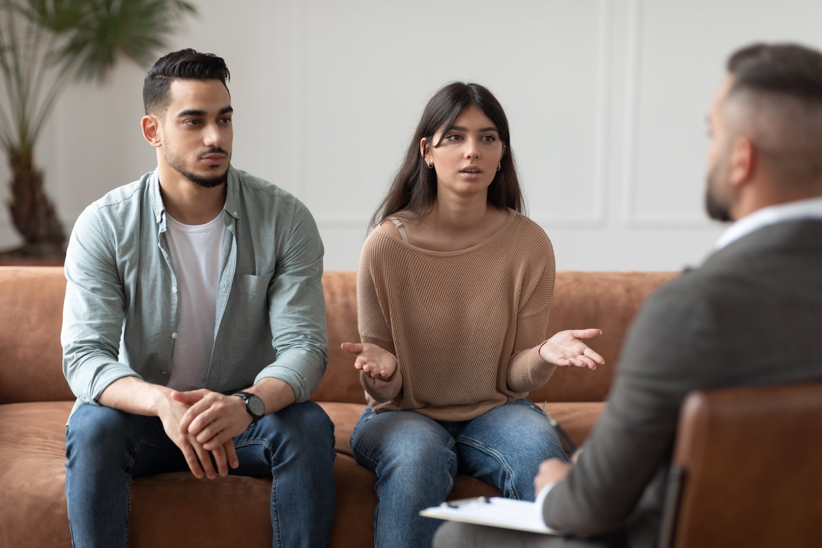 A couple going through divorce coaching session. The coach is explaining the benefits of divorce coaching.